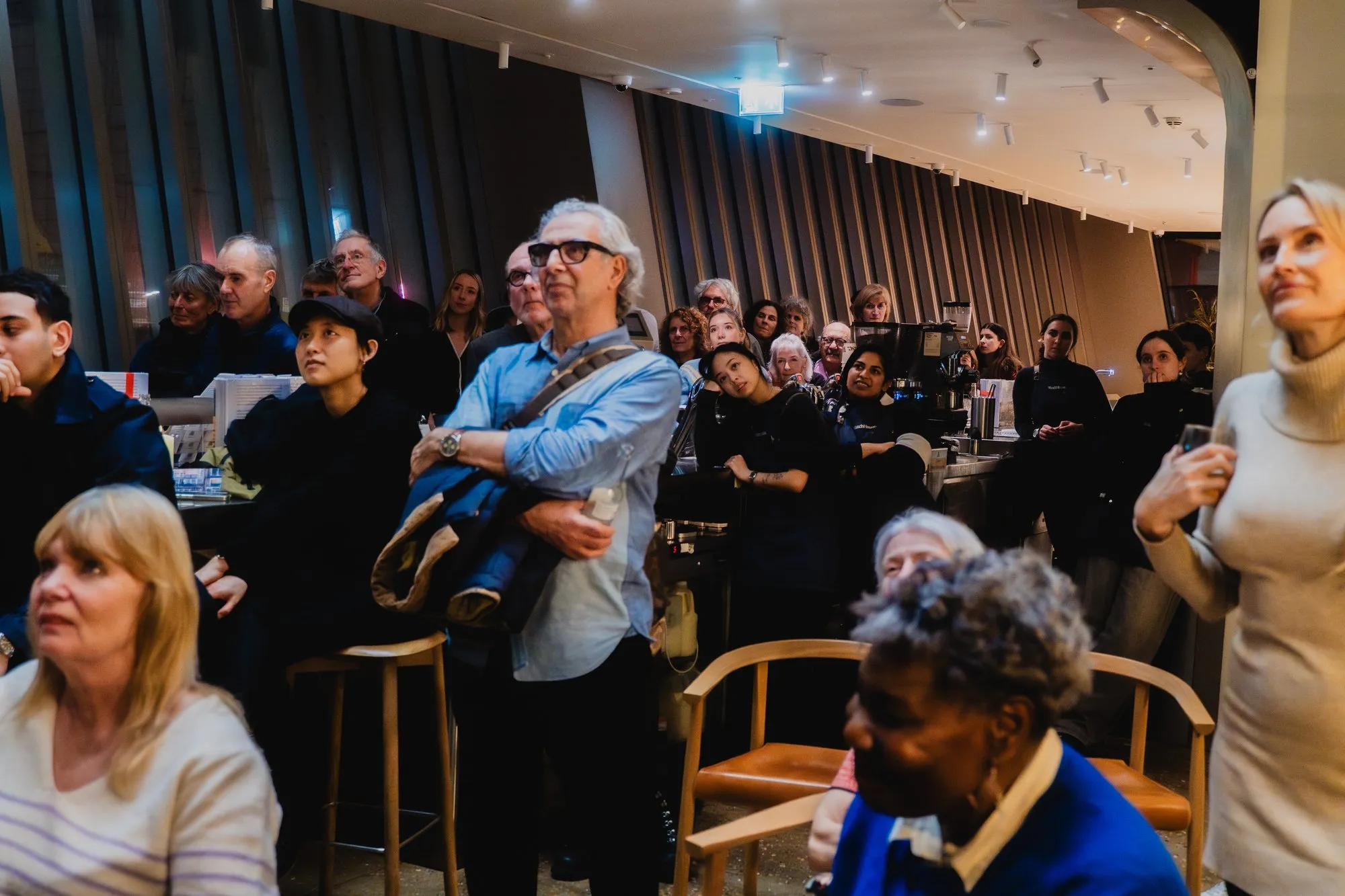 Guests listening to the reading