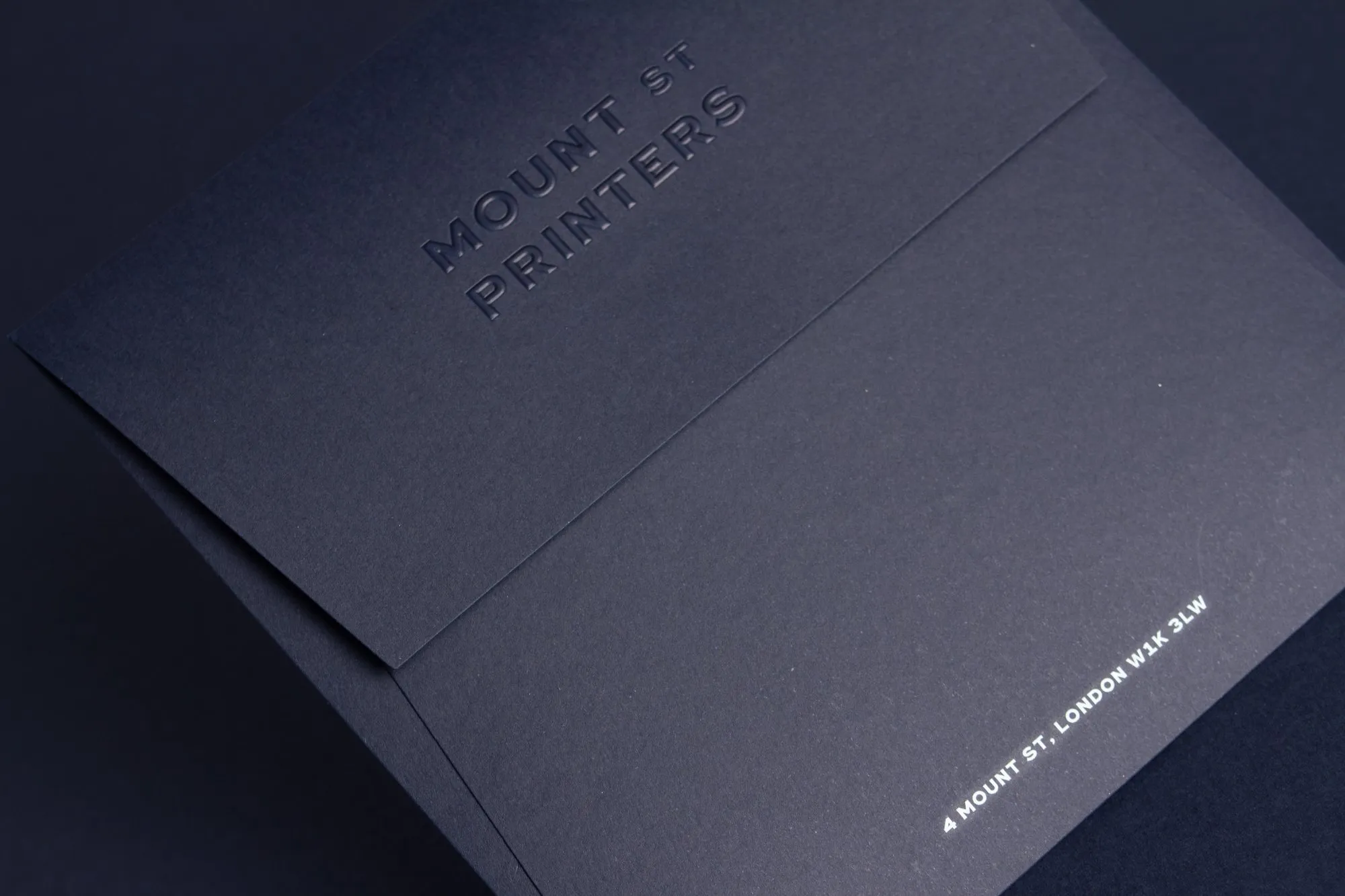 The navy envelope with a blind-embossed Mount Street Printers name