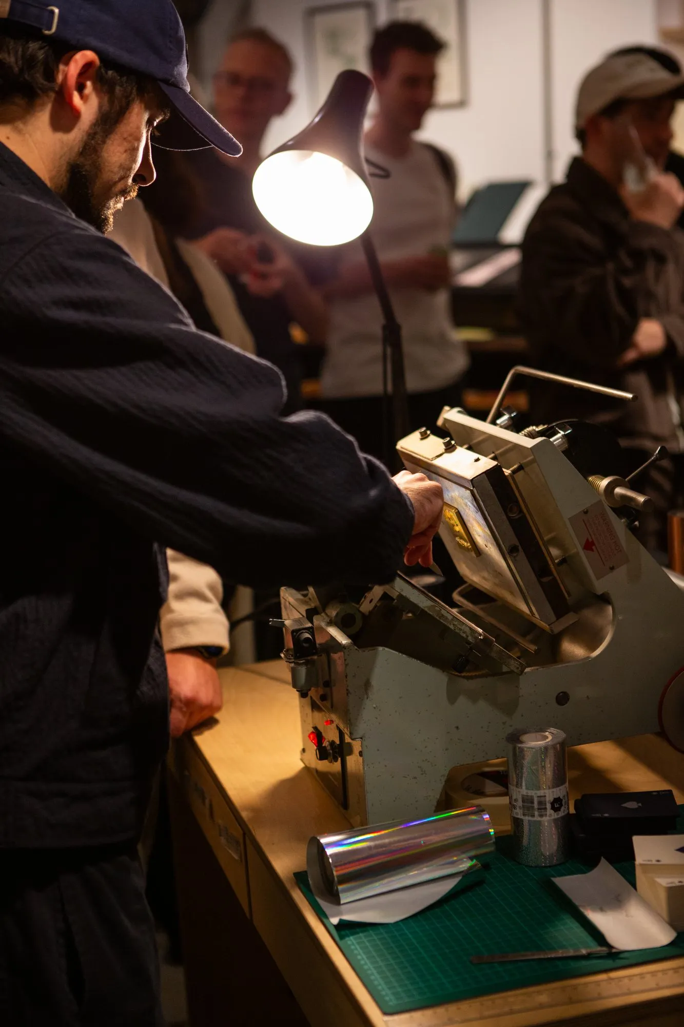 Live foiling on a vintage press during the evening