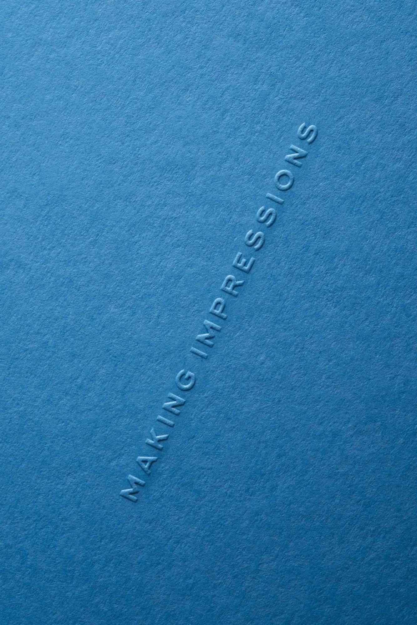 "Making Impressions" blind-embossed on blue card