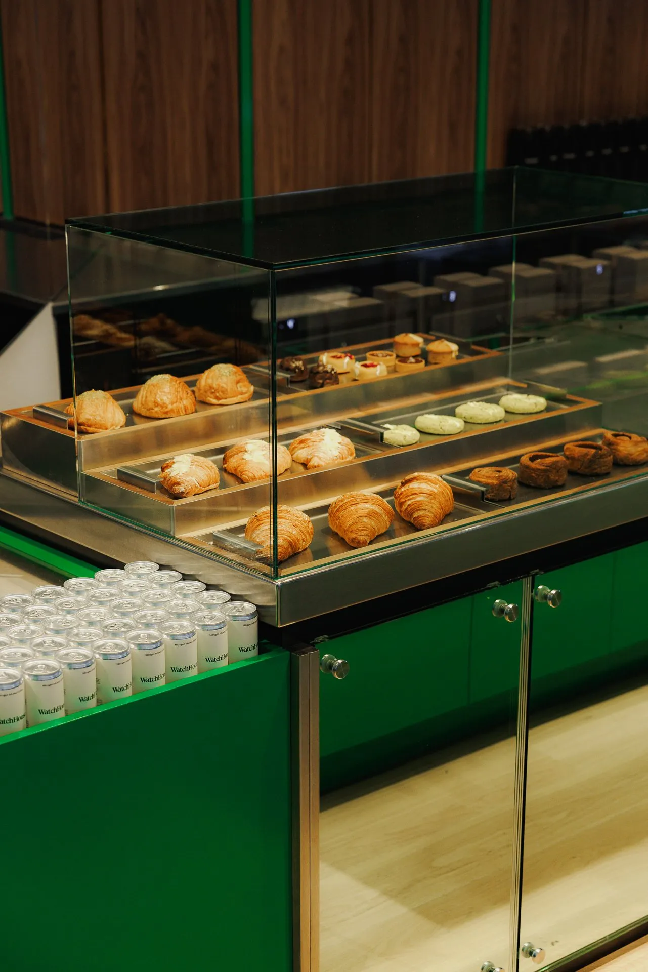 Pastries and cans of nitro coffee on a green WatchHouse counter