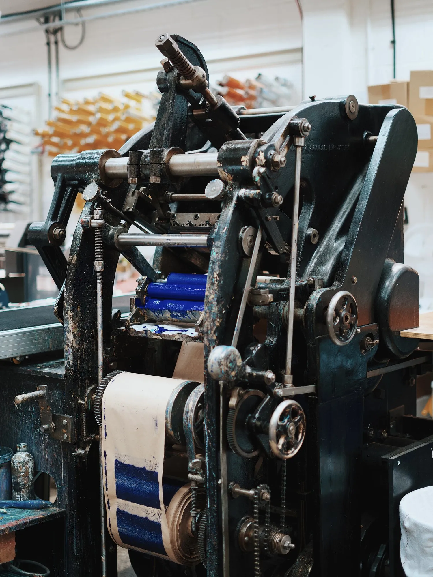 A century-old die-stamping press inked in blue