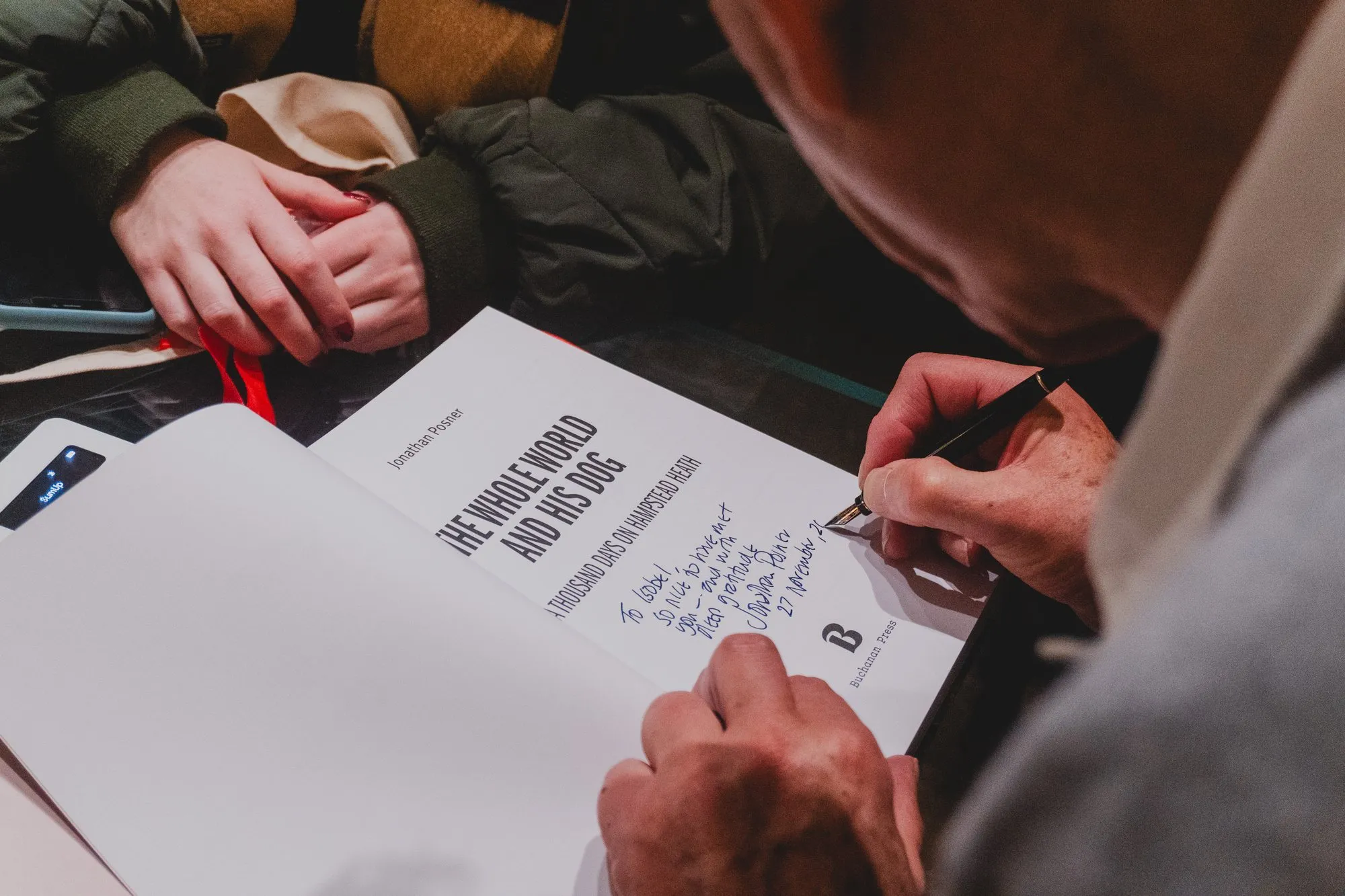 Jonathan Posner signing a copy of the book