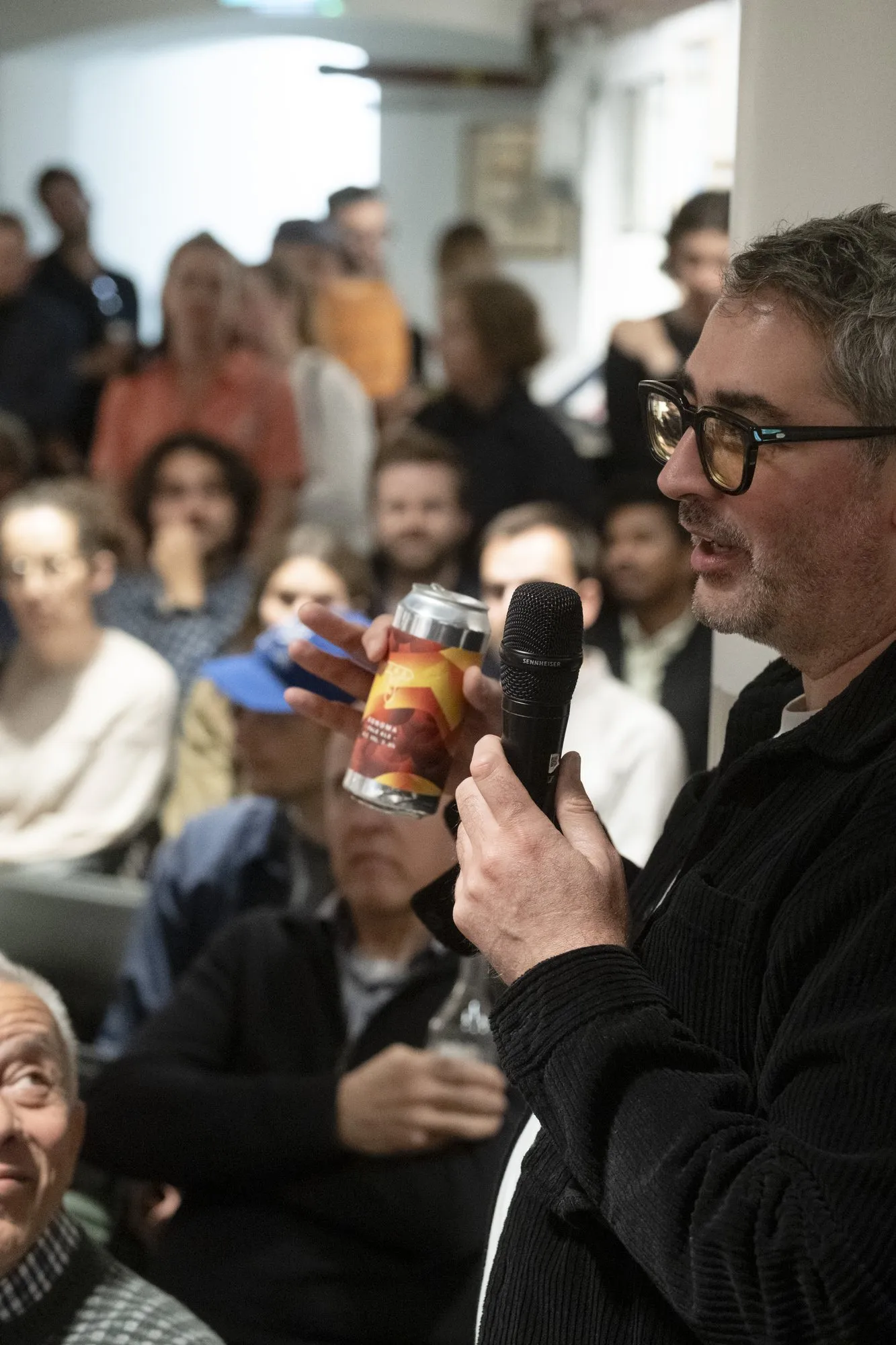 A speaker addressing a full room